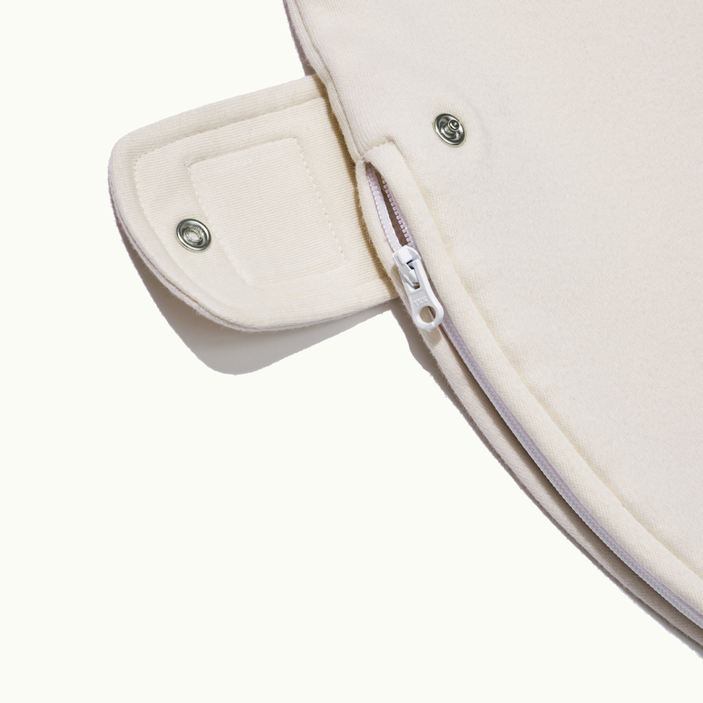 zoomed in on bottom of nanit khaki breathing wear sleeping bag with button undone #color_khaki