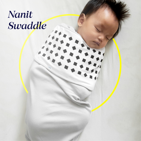 baby sleeping in gray nanit swaddle
