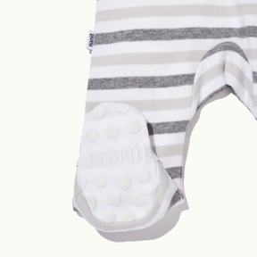 zoomed in on right feet in front view of sleep wear pajamas in bold stripe showing signature foot gripper