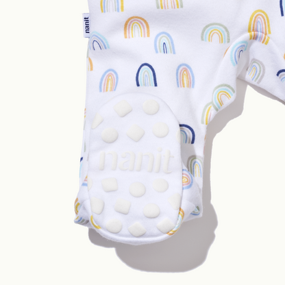 zoomed in on right feet in front view of sleep wear pajamas in sweet rainbows showing signature foot gripper 