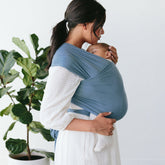 mom holding baby with solly baby wrap carrier #color_cerulean