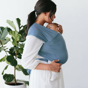 mom holding baby with solly baby wrap carrier