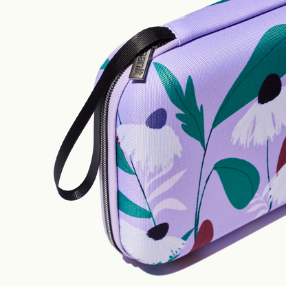 zoomed in picture of gray zipper and strap on purple floral travel case 