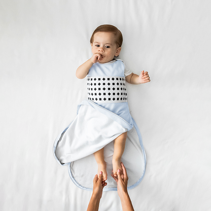 baby wearing nanit powder blue breathing wear sleeping bag with bottom unzipped 